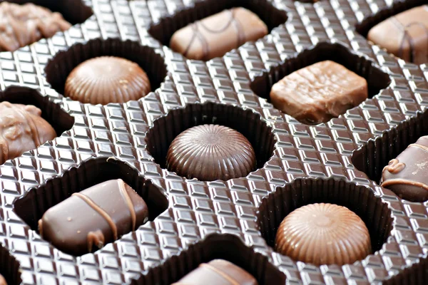 stock image Box of mixed shapes and dark or milk chocolates, at a diagonal.