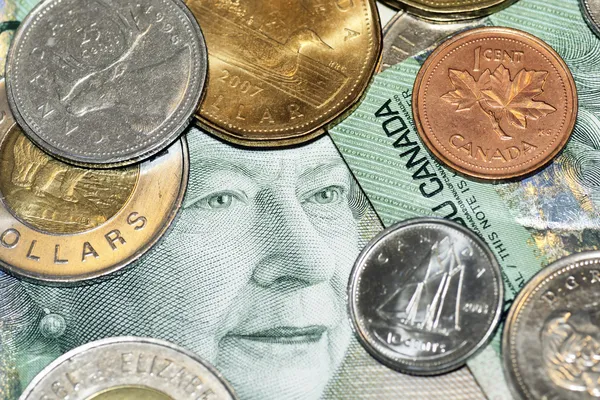 Pengar ansikte och mynt — Stockfoto