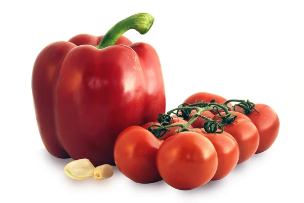 Tomatoes on the vine and red pepper — Stock Photo, Image