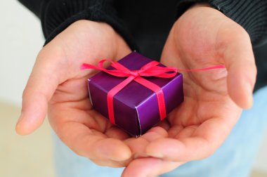 Man holding small gift clipart