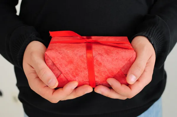 Man holding red gift — Stock Photo, Image