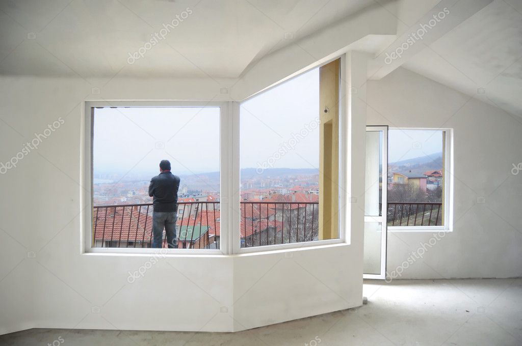 Young man looking from his new home balcony