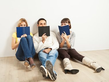 Three amused friends with books clipart