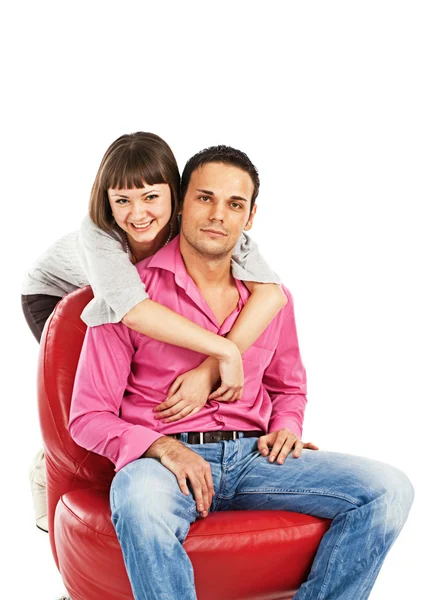 Happy Young Woman Embraces Man Sitting Red Leather Chair — Stock Photo, Image