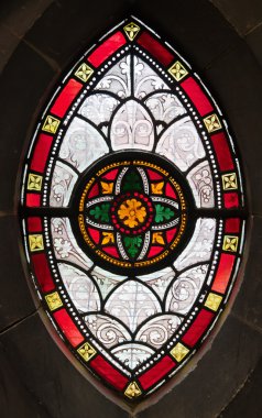 Gothis ornamental stained glass window in a medeval church clipart