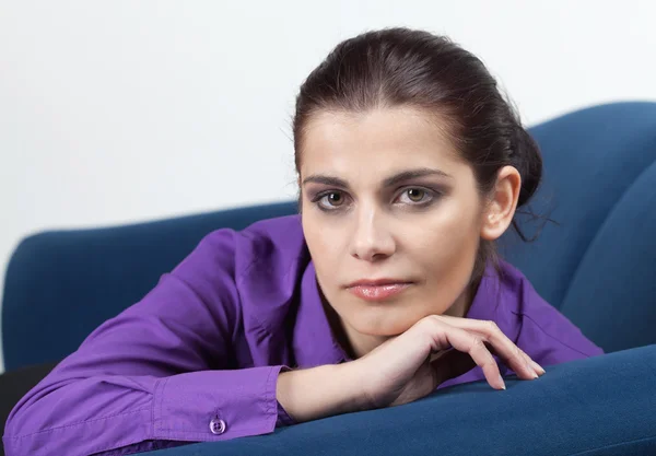 Young woman on a couch — Stock Photo, Image