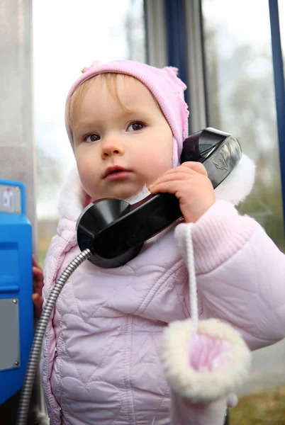 stock image Little emotional girl with a telephone handset