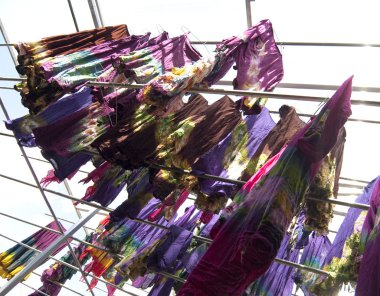 Hand-dyeing clothes drying under sun in Dali Province, China. clipart