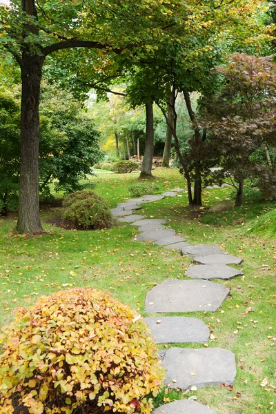 Path from stone in autumn park — Stock Photo, Image