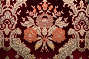 Crimson fabrics with golden pattern clipart