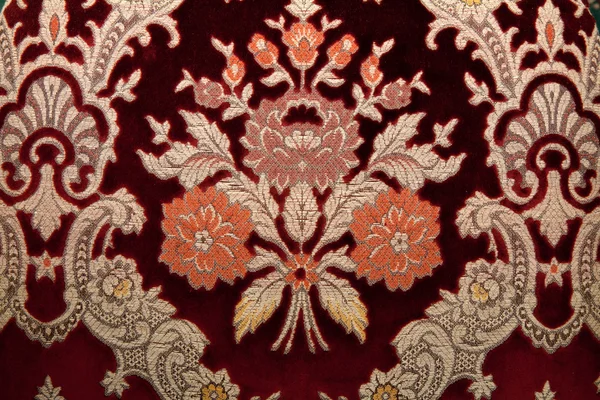 Crimson fabrics with golden pattern — Stock Photo, Image