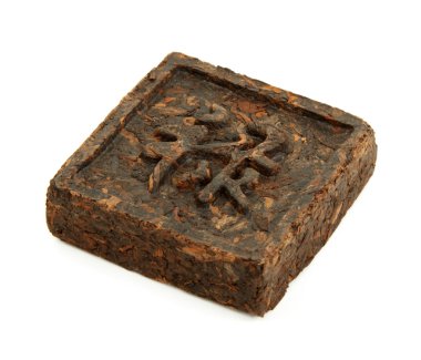 Pressed briquette of green tea with hieroglyphic on white backgr clipart