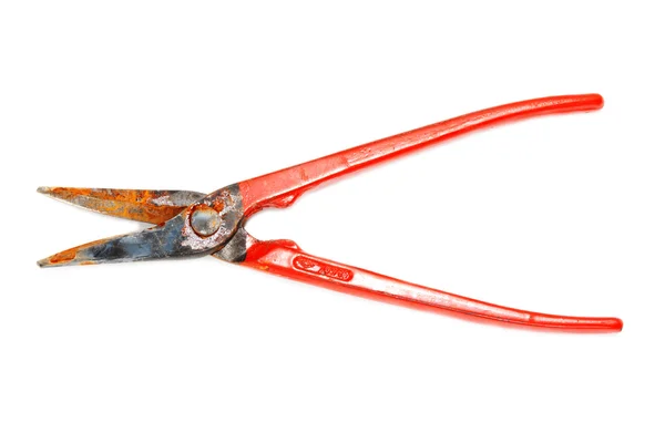 Rusty scissors on metal with red handle — Stock Photo, Image