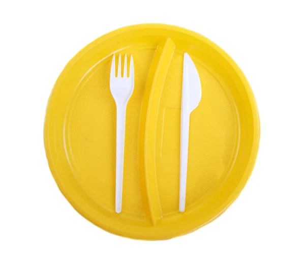 Placa de plástico amarelo, garfo e faca — Fotografia de Stock