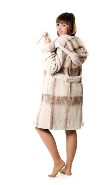 A beautiful young girl in a fur coat — Stock Photo, Image