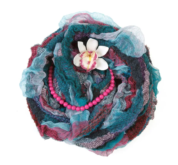 Varicoloured scarf is put with necklace around and flower — Stock Photo, Image