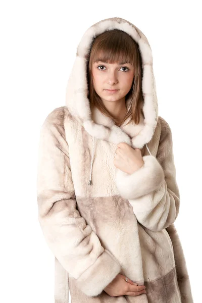 A beautiful young girl in a fur coat — Stock Photo, Image