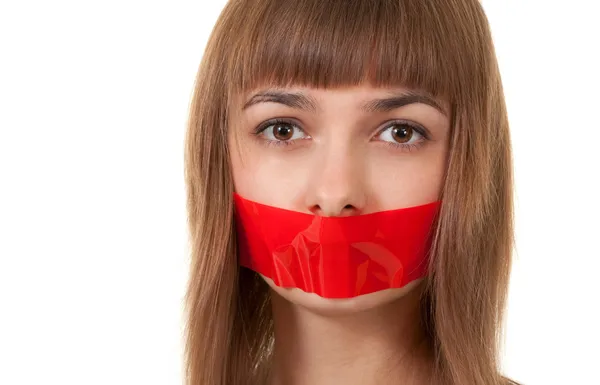 stock image Beautiful girl with her mouth sealed with red tape