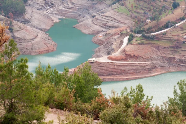 stock image Views of the azure mountain lake through the pine forest