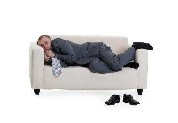 Businessman sleeping on a sofa — Stock Photo, Image