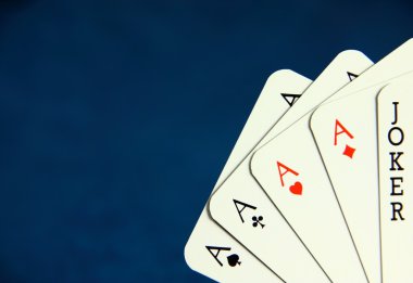 Playing poker cards on dark blue background clipart