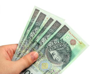 View of hand holding several polish one hundred banknotes clipart