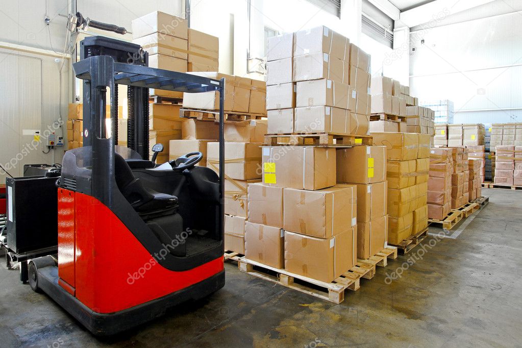 Red forklift in big warehouse with boxes