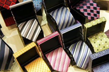 Bunch of colorful ties in gift boxes clipart
