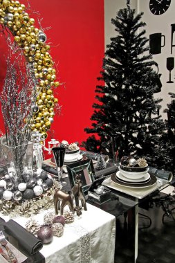 Black Christmas tree and dark table setup clipart