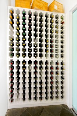 Restaurant shelf with well organized wine bottles clipart