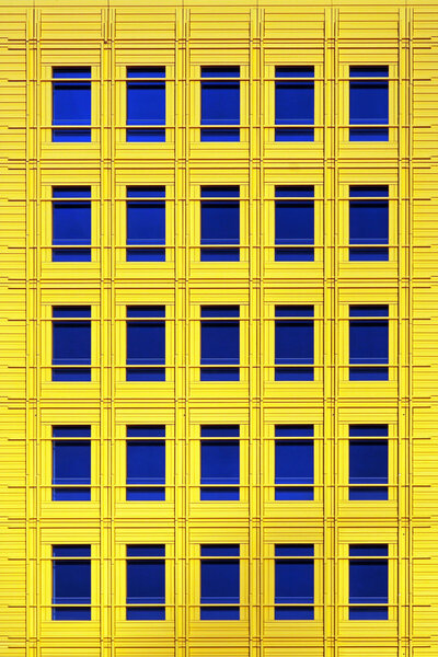 Detail of modern yellow building facade with horizontal stripes
