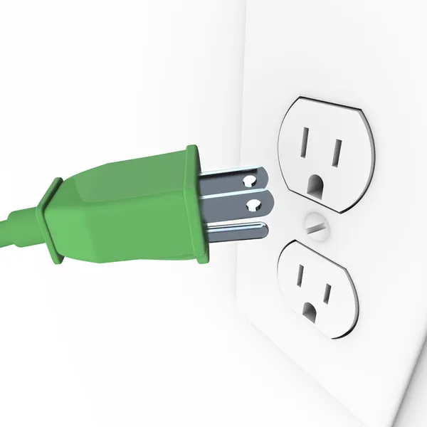 Plugue elétrico verde na tomada de parede — Fotografia de Stock