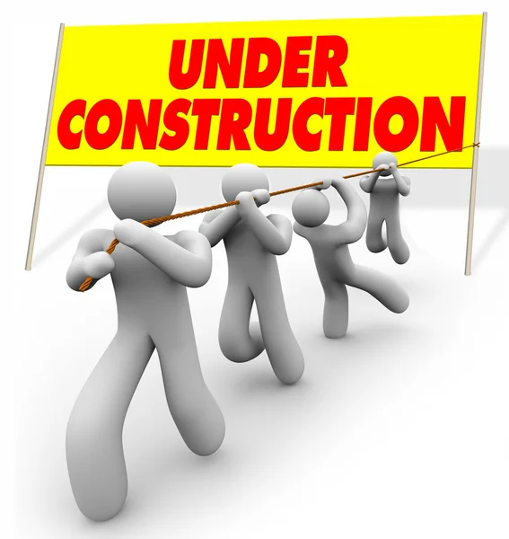 Under Construction - Team Pulling Up Sign — Stock Photo, Image