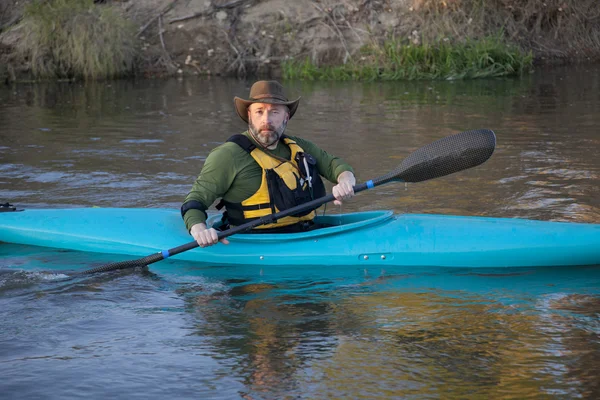 Adult paddler in blue kayak — Stock Photo, Image