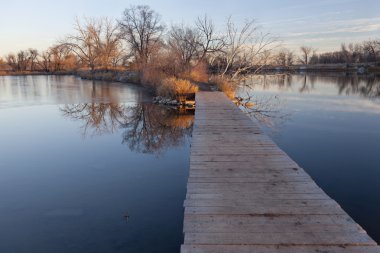 Boardwalk pathway over lake clipart