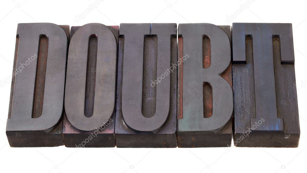 Doubt - word in vintage wooden letterpress printing blocks, stained by color inks, isolated on white