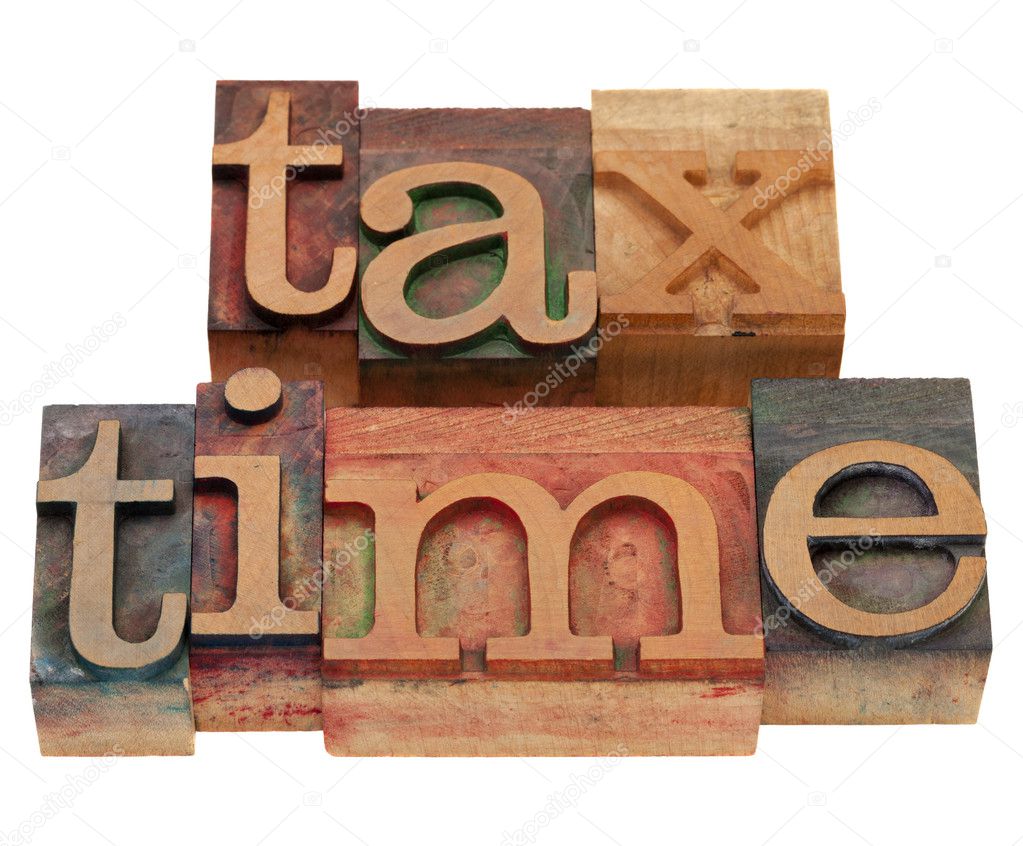 Tax time words in vintage wooden letterpress printing blocks, stained by color inks, isolated on white