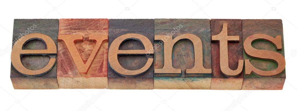 Events word in vintage wooden letterpress printing blocks, stained by color inks, isolated on white