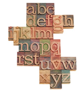 Alphabet - abstract of vintage wooden letterpress printing blocks stained by color inks, isolated on white clipart