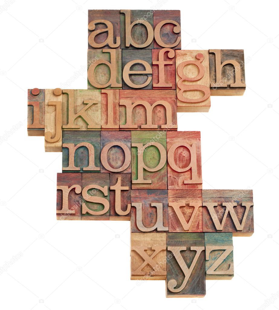 Alphabet - abstract of vintage wooden letterpress printing blocks stained by color inks, isolated on white