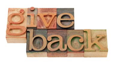 Give back - words in vintage wooden letterpress printing blocks, stained by color inks, isolated on white clipart