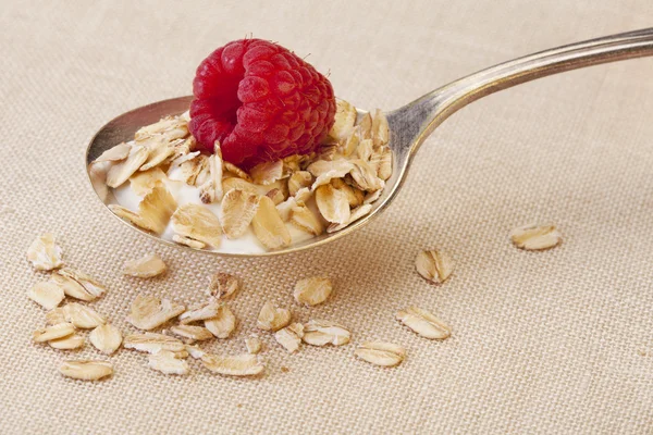 Spoon of cereal with raspberry — Stock Photo, Image