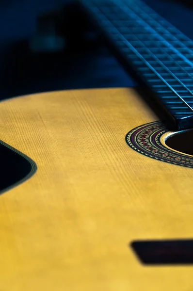 stock image Detail shot of a beautiful acoustic guitar on dark velvet