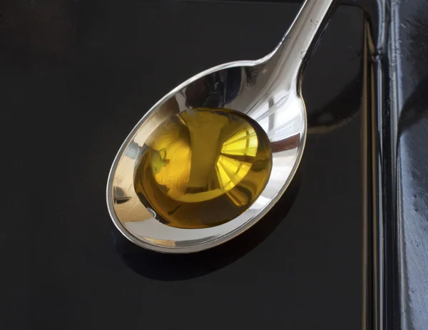 Oil on spoon — Stock Photo, Image