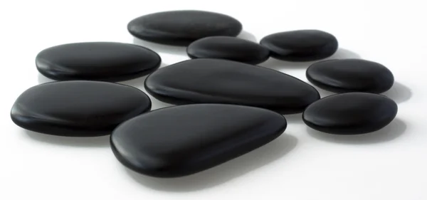 黑色玄武岩石头为按摩在灰色背景的 — 图库照片