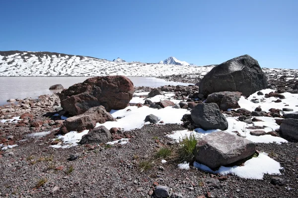 Stones, rocks, snow and mountain lake, Caucasus. — Stock Photo, Image