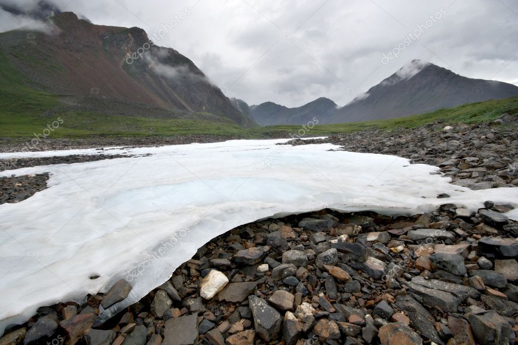 White ice on stones.Sayan mountain valley.Russia.Siberia.