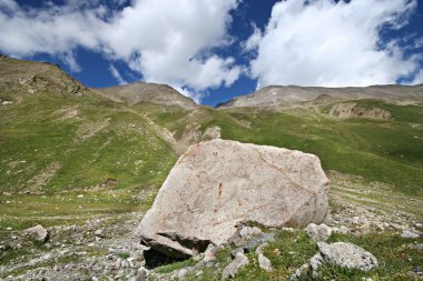 Rocks in valley,Caucasus mountains.Blue sky,clouds