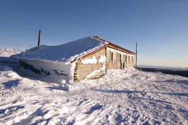 Winter hut in Ural mountains.Russia,taiga,siberia. clipart