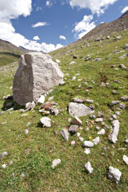 Rocks in valley,Caucasus mountains.Blue sky,clouds